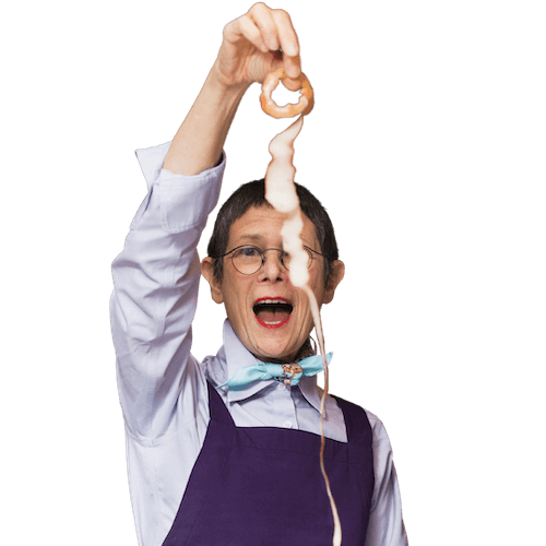 dorie-main-home Image of Dorie Greenspan holding up an apple peel in a single piece